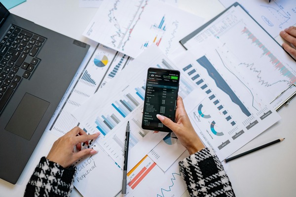 Analyst checking charts on a smartphone