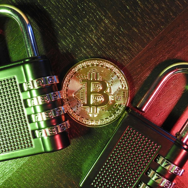Bitcoin coin between metal padlocks