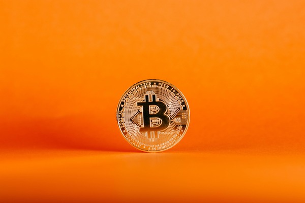 Bitcoin coin on an orange background