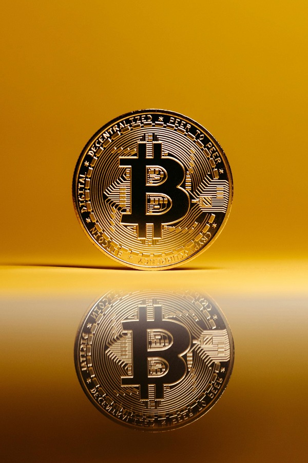 Bitcoin coin reflected on a golden surface