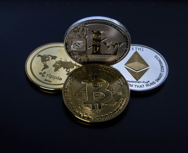 Bitcoin Ethereum and Ripple coins on a dark background
