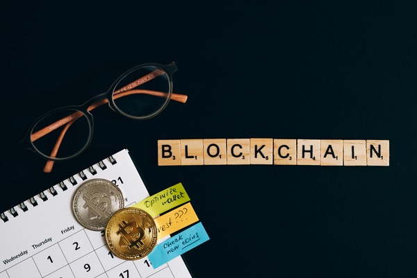 Blockchain letters with a calendar and coins