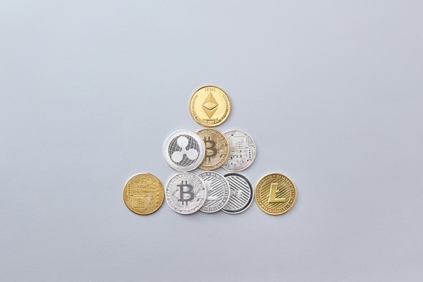 Crypto coins arranged in a pyramid on white