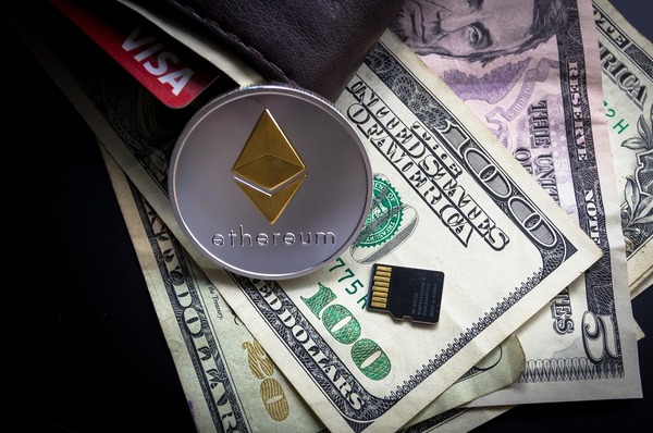Ethereum coin on US dollar bills