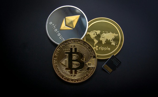 Ethereum Ripple and Bitcoin coins with a memory card