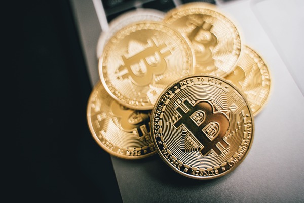 Gold Bitcoin coins stacked on a desk