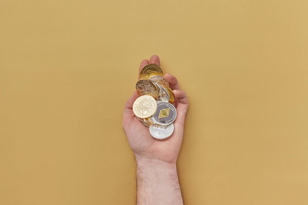 Hand holding a handful of crypto coins