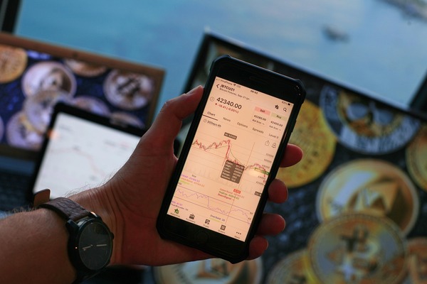 Hand holding a phone with a crypto app