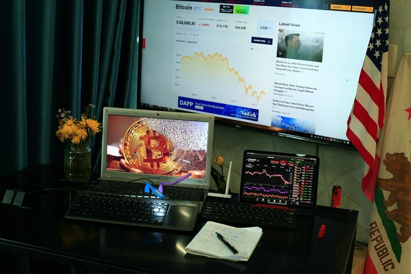 Home office with crypto news on screens