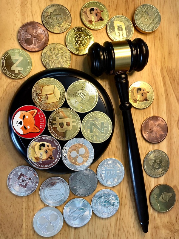 Judge gavel over a tray of crypto coins