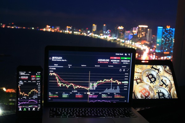 Laptop with charts and city lights at night
