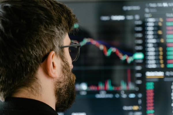 Man looking at trading screens