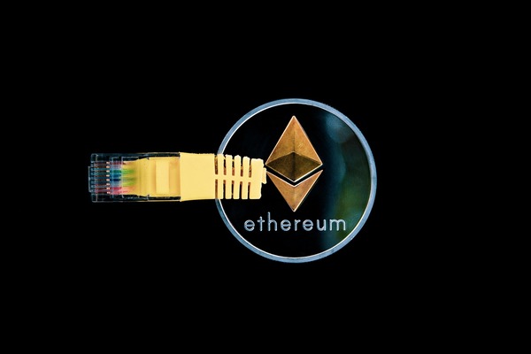 Network cable plugged into an Ethereum coin