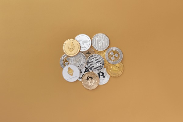 Scattered crypto coins on a beige background