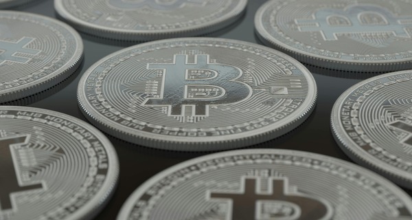 Silver Bitcoin coins arranged in rows