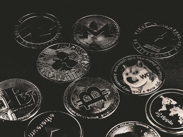 Silver crypto coins in black and white
