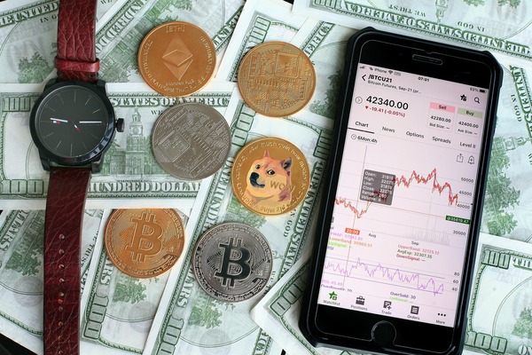 Smartphone with a crypto app coins and dollar bills