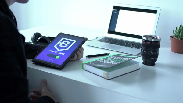 Tablet with a blockchain app on a white desk