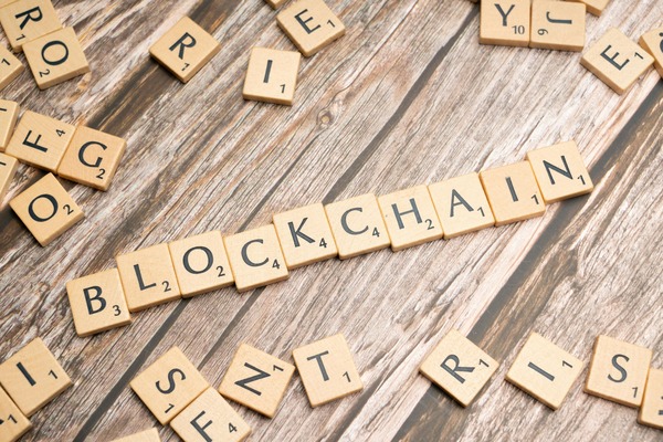 Wooden letter tiles spelling blockchain